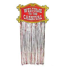 a welcome to the carnival sign with fringes hanging from it's back end