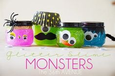 three jars with googly eyes and mustaches painted to look like monsters, the third one has a spider on it