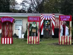 three circus booths in front of a house decorated with clowns and striped red and white tents