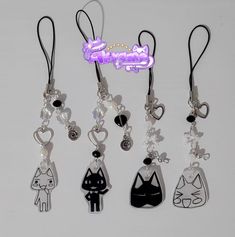 several different types of key chains with charms attached to them, including cats and hearts