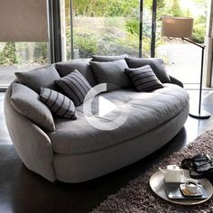 a living room filled with furniture and a large window