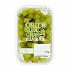 green seedless grapes in a plastic container on a white background with the label below it