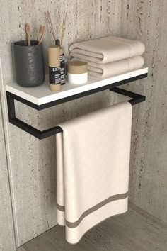 a towel rack with two towels on it next to a cup and toothbrush holder