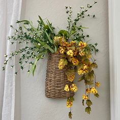 a basket with flowers hanging on the wall