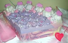 there is a cake decorated with pink and purple icing