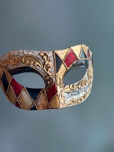 This Venetian style mask in red, black, and gold is perfect for any formal occasion or masquerade event! Thank you for supporting small businesses and hope our products bring you and loved ones some joy and humor in these trying times.    I N C L U D E D Masks come with matching double sided satin ribbons attached. S I Z E  Adult size. Detailed dimensions available upon request. C U S T O M I Z A T I O N If you would like to color & embellish the mask to match your costume/dress, choose custom color and get in touch, we love to work on custom orders!  C O N T A C T  Please contact us via ETSY messages. P H O T O  Images displayed on this listing are property of www.higginscreek.com A B O U T HigginsCreek makes elegant face Masks for masquerade balls, Prom Dances, Bachelorette parties, Grad Painted Masquerade Mask, Masqurade Mask, Mens Mask, Masquerade Event, Masquerade Mask Diy, Harlequin Mask, Elegant Face Mask, Mask Venetian, Masquerade Prom