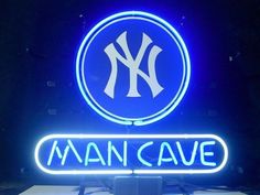 the new york yankees man cave neon sign is lit up with blue and white letters