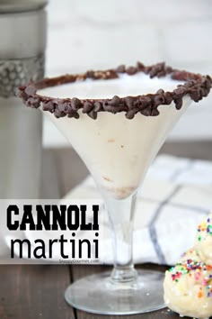 a martini with chocolate sprinkles in it and two donuts on the side