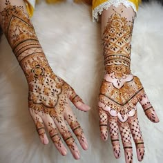 two hands with henna designs on them