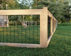 an animal cage in the middle of some grass