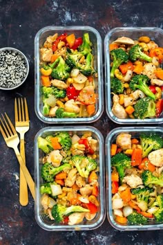 four plastic containers filled with different types of food next to two forks and spoons