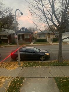 a car parked on the side of a street next to a red light