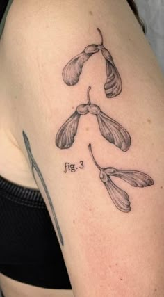 a woman's arm with three flowers on it and the number five is shown