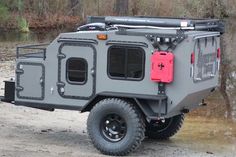 an off - road vehicle is parked in the dirt