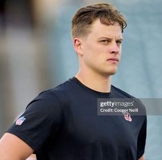 a close up of a young man wearing a black shirt