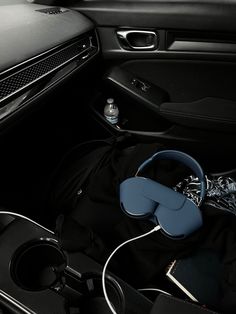 the interior of a car with headphones and other items in it's compartment