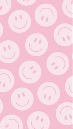 a pink background with smiley faces on it