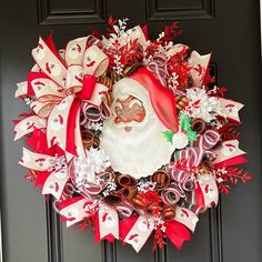 a christmas wreath with santa's face and candy canes on the front door