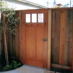 a wooden door with a tree in the corner