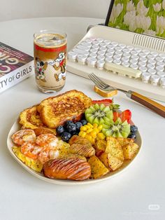 a plate full of food next to a computer keyboard