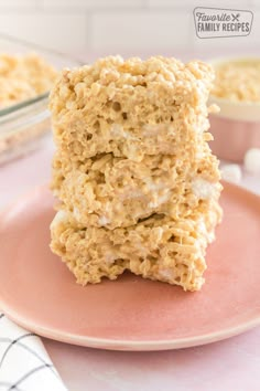 three oatmeal bars stacked on top of each other on a pink plate