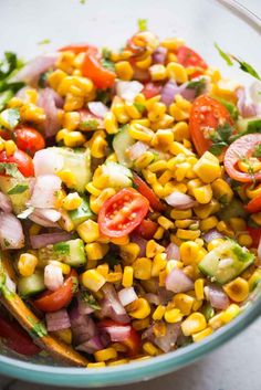 a bowl filled with corn salad on top of a table