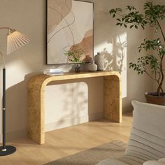 a living room with a couch, table and lamp in front of a window on the wall