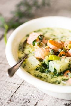 a white bowl filled with soup on top of a table