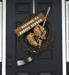 a hockey wreath on the front door of a house with gloves and an ice hockey stick