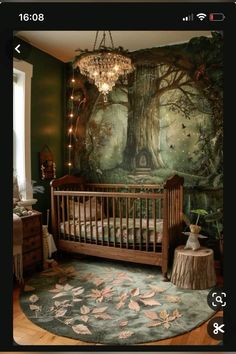 a baby's room with a tree mural on the wall and a chandelier hanging from the ceiling