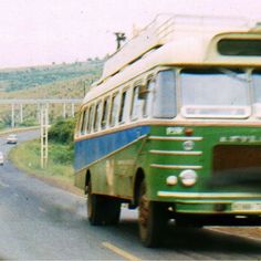 an old bus is driving down the road