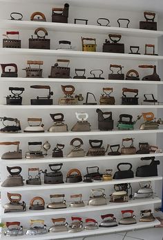 a room filled with lots of different types of old fashioned telephones on shelving