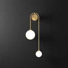 two lights are hanging on the wall next to each other, one is white and the other is gold