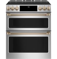 two ovens side by side, one with gold trim and the other blacktop