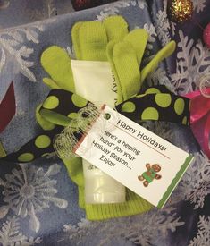 a green sock with a tag on it sitting next to some christmas decorations