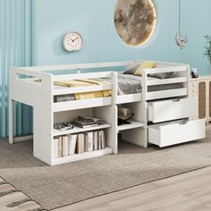 a white bed with drawers underneath it in a blue room next to a clock and bookshelf