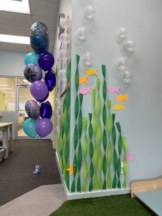 an office decorated with balloons and fish