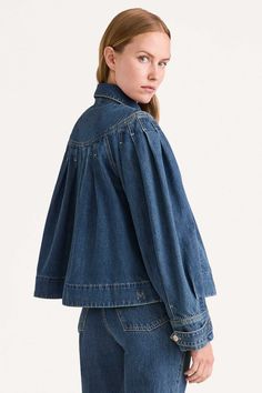 An easy-to-wear denim jacket with an A-line silhouette, the EASTON BLUE is Merlette's interpretation of a timeless classic. With a point collar, the jacket features contrast stitched pleats at the yoke, custom hardware and an embroidered Merlette 'M' on the back hem. The pockets are also decorated with signature Kantha embroidery. The EASTON BLUE is crafted in organic GOTS certified cotton denim and treated with a responsible ozone wash to create unique variations in tone. Pair it with the BEACO Denim Embroidery Jacket, Denim Jacket Outfit Women, Bleached Denim Jacket, Jacket Silhouette, Designer Denim Jacket, Jacket Ideas, Tiered Dresses, Kantha Embroidery, Tiered Tops