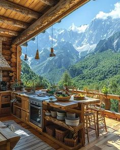 an outdoor kitchen and dining area with mountains in the backgrounnd, surrounded by wood flooring