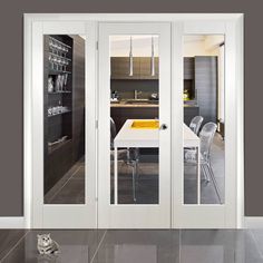 an open kitchen and dining room with glass doors