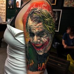 a woman with a joker tattoo on her arm