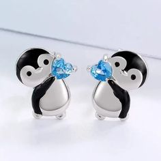 Please Look At Both Pics. The First Pic Has Been Touched Up For Clarity (Penguin Is Black And Silver, Not Black And White) Add A Touch Of Cuteness To Your Outfit With These Little Penguin Holding Blue Heart Stud Earrings. These Earrings Feature A Black And Silver Penguin Holding A Blue Heart, Perfect For Any Occasion. The Earrings Are Made Of Zinc Alloy And Have Silicone Push Back Closures, Ensuring They Stay Secure On Your Lobes. At Approximately 0.5 Inch From Top To Bottom, These Earrings Are Blue Heart Earrings, Penguin Earrings, Teardrop Silver Earrings, Club Earrings, Baublebar Earrings, Cute Penguin, 18k Gold Earrings, Heart Crystal, Teardrop Dangle Earrings