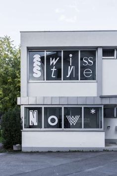 the front of a building with windows and letters on it