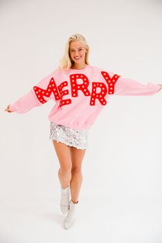 Spread holiday cheer in style with our Merry Star Pink Pullover! This playful pullover is perfect for any festive occasion, featuring bold red "Merry" cutout letters and shimmering silver star patches. Stay cozy and stand out in this quirky and fun pullover. All orders are currently shipping within 14 business days. To receive item quicker, expedited shipping is available at checkout. **All Christmas orders must be placed with expedited shipping to guarantee delivery by Dec. 24 if placed after D Merry And Bright Outfit, Funky Christmas Outfit, Trends Winter 2024, Pink And Red Christmas Aesthetic, Holiday Party Aesthetic, Pink Christmas Outfit, Wishlist Ideas Aesthetic, Holiday Fashion Editorial, Pink Christmas Sweater