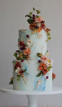 a three tiered cake with flowers on it