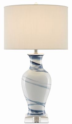 a blue and white lamp with a beige shade