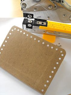 a pair of scissors sitting on top of a piece of paper next to a hole punch