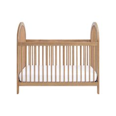 a wooden crib with white sheets on the bottom and sides, against a white background