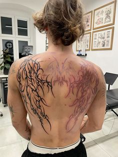 a woman with tattoos on her back