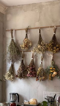 dried flowers hanging on a wall in a kitchen